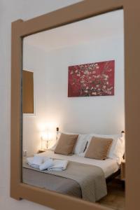 a mirror reflection of a bed in a bedroom at Corfu Glyfada Beach Apartment 25 in Glyfada +43 photos