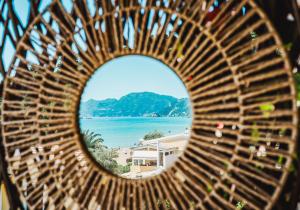 a view of the ocean from a wooden bench at Corfu Glyfada Beach Apartment 25 in Glyfada