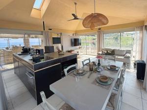 a kitchen and living room with a table and chairs at Turtle Home in Skala
