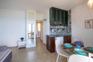 a kitchen and dining room with a table and chairs at Corfu Glyfada Beach Apartment 25 in Glyfada