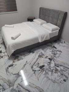 a bedroom with a bed with a marble floor at GP StayIn in Lunas