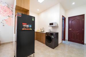 a kitchen with a washer and dryer in a room at The Pivot Suite Ben Thanh - District 1 in Ho Chi Minh City