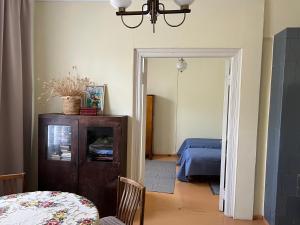 a room with a bedroom with a bed and a table at Vekšin Old Town & Promenade Apartment, Haapsalu in Haapsalu