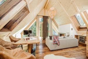 a living room with a couch and a table and chairs at Almhof Roswitha in Hippach