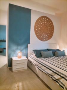 a bedroom with a large bed and a wall at APPARTAMENTO CORALLO with PRIVATE GARDEN in Olbia