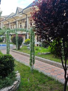 a building with a brick path in front of a building at Shodlik Hostel in Andizhan