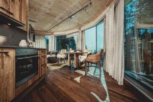 a kitchen and dining room with a table and chairs at Almhof Roswitha in Hippach