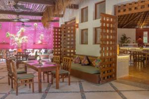 a restaurant with a table and chairs and purple walls at Villas HM Paraiso del Mar in Holbox Island