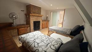 a living room with a bed and a fireplace at Kampenhout appartement met terras en 4 slaap kamers in Kampenhout