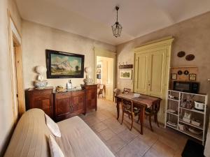 a living room with a table and a dining room at A casa di Bianca in Portacomaro