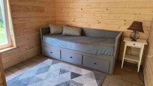 a bedroom with a bed in a log cabin at Leśne Doliny 38 in Zwiartów +18 photos