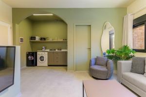 a living room with a couch and a chair at Capri 2-BR Apartment In Bahsa Batroun in Batroûn