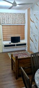 a room with a window with a table and a laptop at Shayus Homestay in Kampong Alor