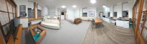 a large living room with a couch and a table at Castle Studio Apartment in Dunedin +32 photos