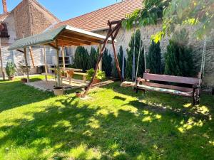 a park with a bench and a gazebo at Apartmány Podhorsky in Štúrovo