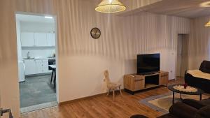 a living room with a couch and a television at Apartment 42 in Ljubuški +2 photos