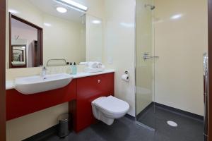 a bathroom with a toilet and a sink and a shower at Fire Service College in Moreton in Marsh