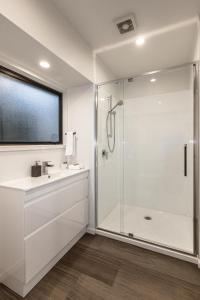 a bathroom with a shower and a sink at Alpine Chalets in National Park