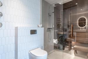 a bathroom with a shower and a toilet and a sink at Marienholm Seaview Apartment in Haapsalu +8 photos