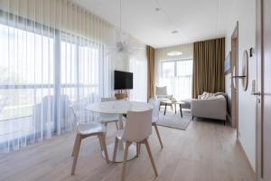 a living room with a table and chairs at Marienholm Seaview Apartment in Haapsalu