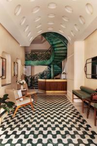 a hotel lobby with a large room with a staircase at Abode Jaipur in Jaipur