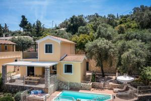 a villa with a swimming pool and a house at Villas Muscalas by Konnect, 200m from the Beach in Lákka
