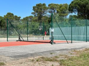 a basketball hoop on a court with a fence at Soucado in Fréjus