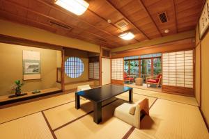 a living room with a table and a chair at Nara Kasugaokuyama Tsukihitei in Nara