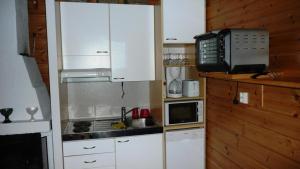 a small kitchen with a sink and a microwave at Lomaniini in Tahkovuori +8 photos