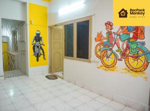 a room with a painting of a bike on the wall at Zapstays-Homestays in Visakhapatnam