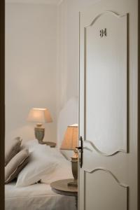 an open door to a bed with a table at Villa Telli in Garda