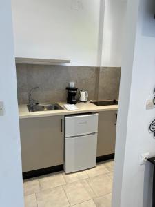 a small kitchen with a sink and a counter at Gardenia studios in Nydri