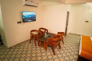 a dining room with a table and chairs at Corbett Retreat in Rāmnagar