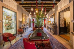 a lobby with a table and chairs in a room at Palazzo Trezza in Verona +54 photos