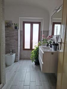 a bathroom with a tub and a toilet and a sink at Su ciaccu in Nulvi +19 photos
