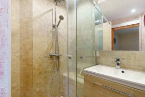 a shower with a glass door next to a sink and a mirror at Le Logis des Douves in Tiffauges +53 photos