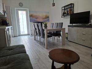a living room with a table and chairs at Su ciaccu in Nulvi