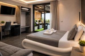 a hotel room with a large bed with towels on it at Residence Villa Rosa dei Venti in Cinisi