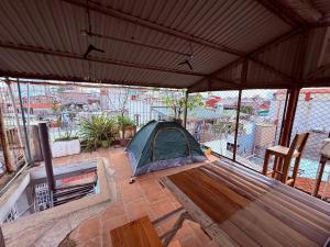a tent on a patio with a view of a city at Local Homestay in Hanoi