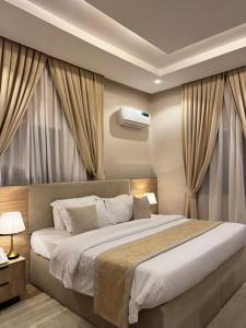 a bedroom with a large bed with curtains at Roseann Gold Boutique Hotel in Kusafe
