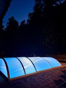 a large greenhouse is lit up at night at Penzión Astoria - bazén a oddych na Liptove in ľubochňa