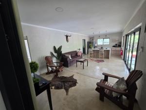 a living room with a couch and a table at Taíta Lodge in Marloth Park