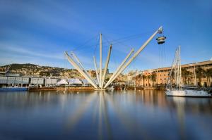 a large bridge over a body of water with boats at Fornaro Apartments in Genoa