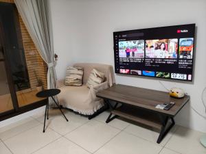 a living room with a table and a tv at Daiwen Homestay in Jiaoxi