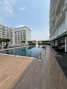 a large swimming pool in the middle of a building at The Comfort stays gomti nagar in Lucknow