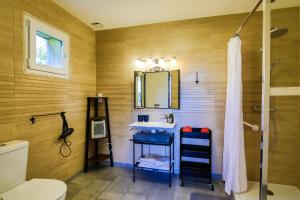 a bathroom with a sink and a mirror at Studio Le Jardin in Lison