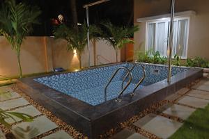 a swimming pool in a house with plants at MHOMES Resort - Madurai in Alagar Kovil