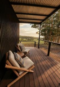 two chairs on a wooden deck with a view at Heyscape Denmark in Denmark