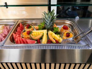 a tray of fruits and vegetables on a buffet at Residence Villa Rosa dei Venti in Cinisi