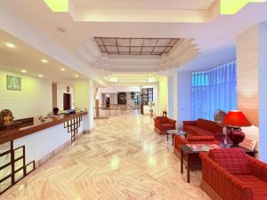 a lobby with red couches and a bar at Hotel Garden Panvel - Near Navi Mumbai Airport in Navi Mumbai